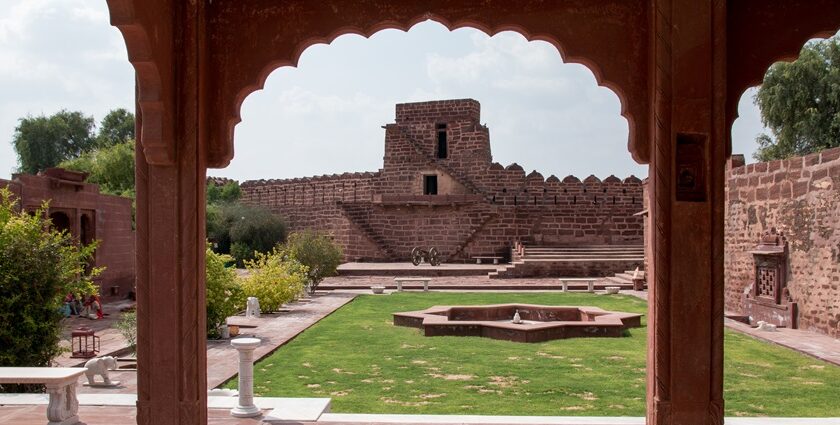 A view of a fort elegantly nestled on the lush green sprawling lands of Rajasthan.