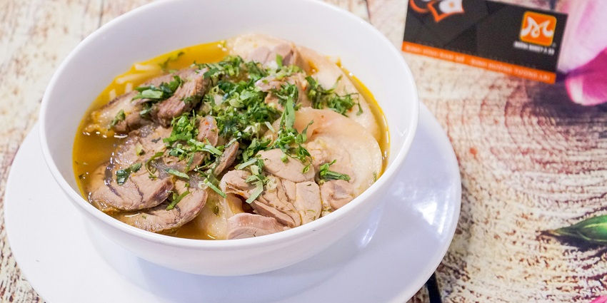Image of piping hot pork dish served on a plate - Harvest Festival of Tripura.