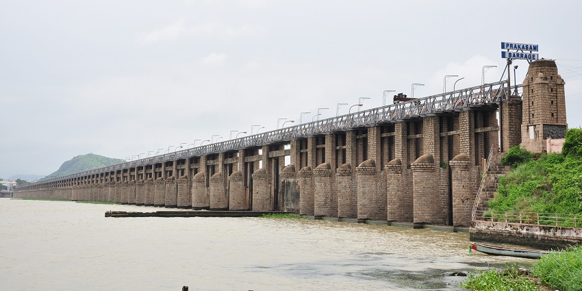 Prakasam Barrage spans a river, showcasing its impressive structure and scenic surroundings.