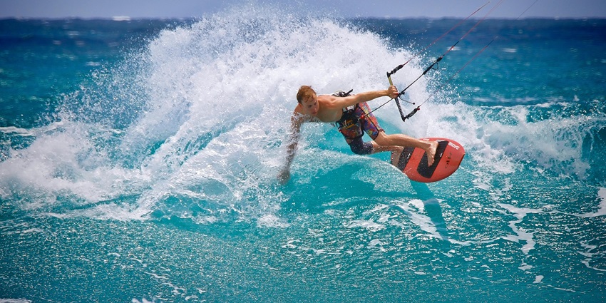 A stunning view of a man enjoying adventure activities on a body of water during the day.