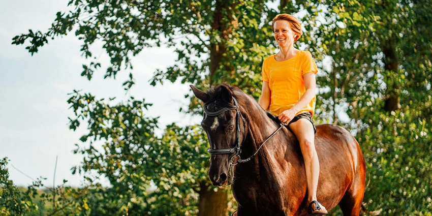 Woman riding a horse, capturing the outdoor adventure at Prithviraj Adventure Park.