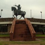 Explore Prithviraj Chauhan fort with a majestic backdrop, attracting tourists.