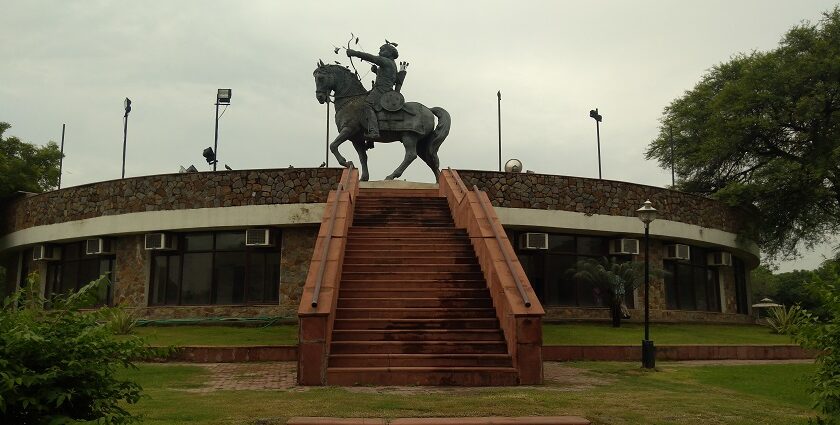 Explore Prithviraj Chauhan fort with a majestic backdrop, attracting tourists.