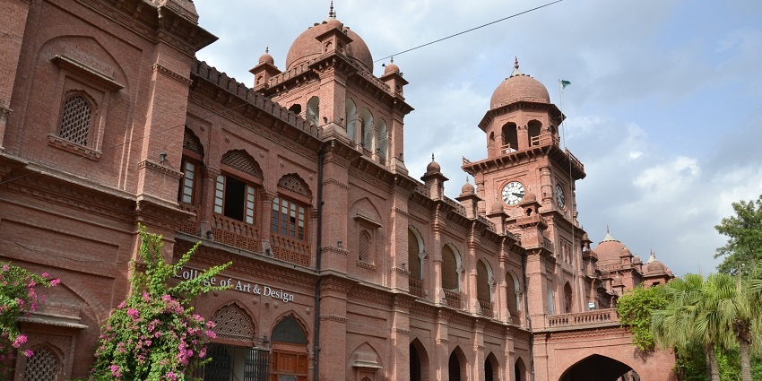 A breathtaking view of a museum in Punjab with brown architecture and lush greenery.