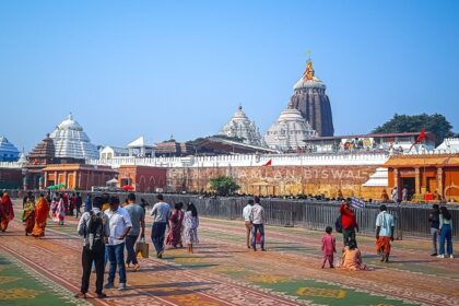 Visitors explore the vast grounds of Puri Temple