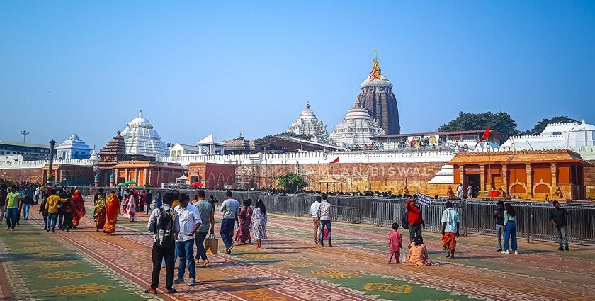 Visitors explore the vast grounds of Puri Temple