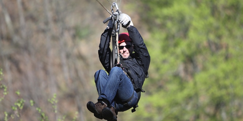 Man on a zip line, enjoying the excitement at the Pushkar Adventure Park.