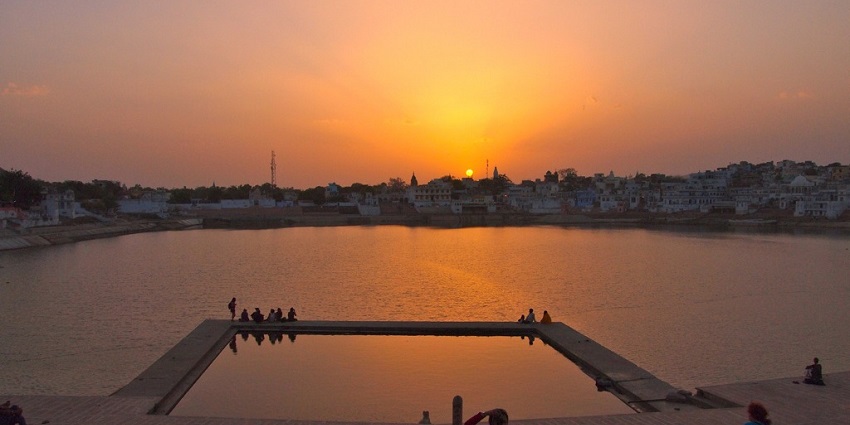 Nightlife in Pushkar Lake at dusk features serene ghats, temple bells, and peaceful reflection