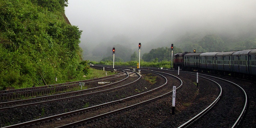 Scenic image of the beautiful train track going through the hills amsit the forest
