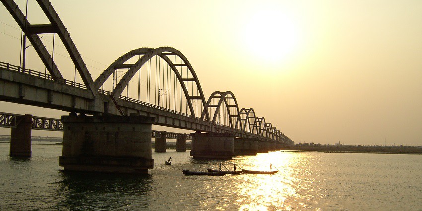 A picture of an arch bridge over the famous Godavari River taken during the golden hour