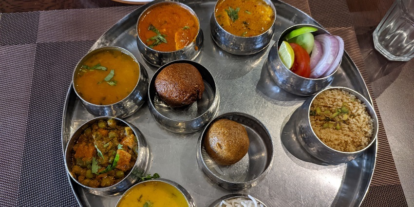 One of the best foods in Kota - Rajasthani Thali: dal, baati, and diverse flavorful dishes.