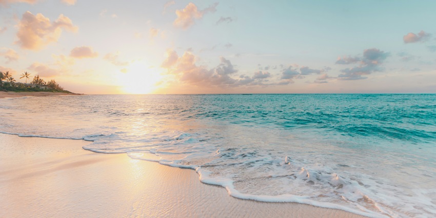 A glimpse of turquoise-blue waters meeting the golden pristine sands at Rajbagh Beach.
