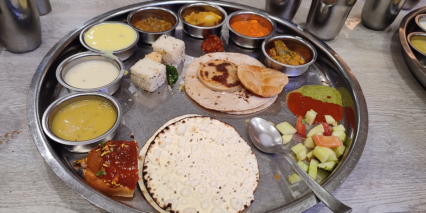 A mouth-watering view of an authentic Gujarati thali, the best food in Dwarka, Gujarat.