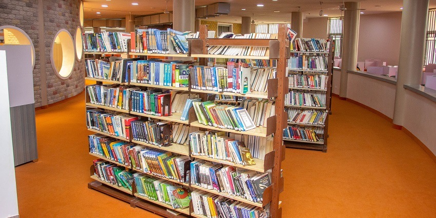 Neatly arranged bookshelves in Rajkot Public Library, filled with a wide range of books and genres.
