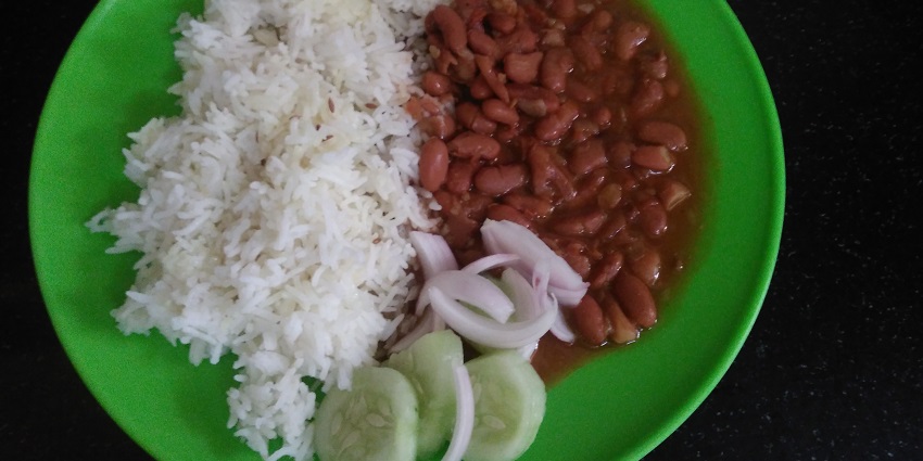 Rajma chawal served with onions and cucumbers, makes a fulfilling meal for all foodies