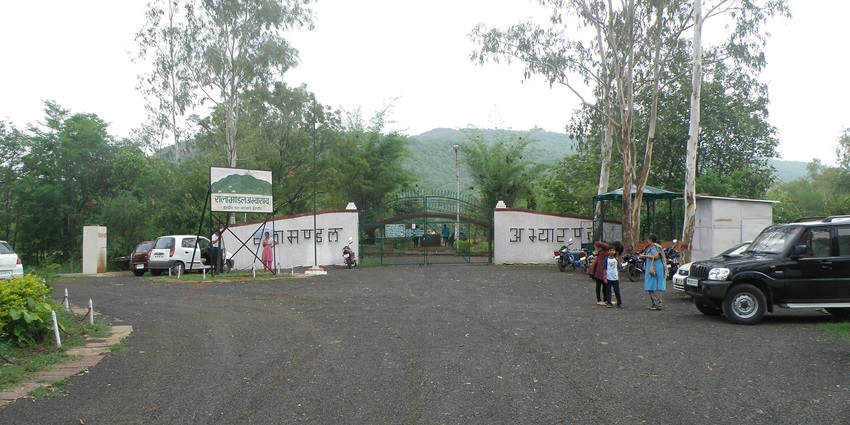 Entrance to Ralamandal Sanctuary near Indore, featuring a stone gateway and lush greenery.