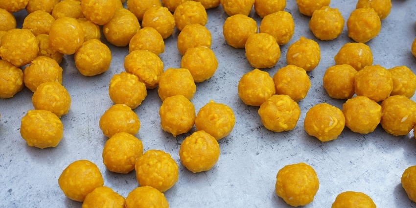 Orange ladoos in making - Ram Ladoo and any other sweet ladoos are Best Food In Delhi