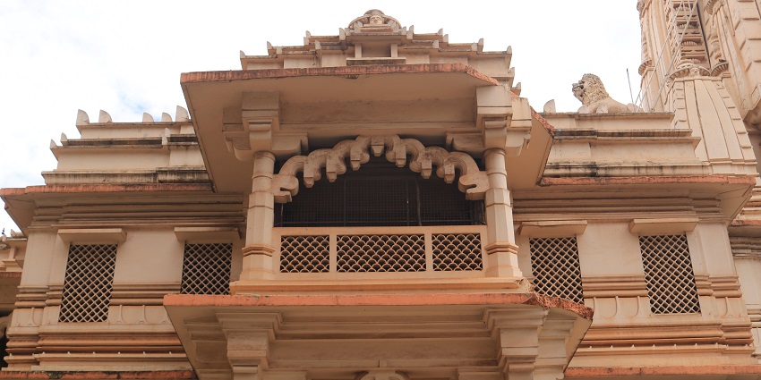 A lower angle view of the intricately carved Ram Madhi Mandir in Surat, Gujarat