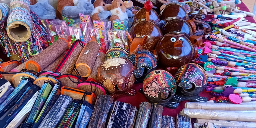 A picture of a street-side stall selling various stationery products and toys
