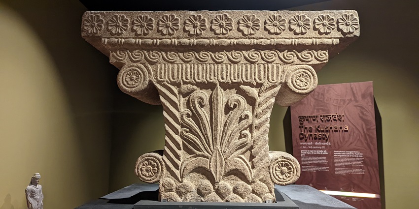 A sandstone pillar from the Kushana dynasties era has various designs carved on it