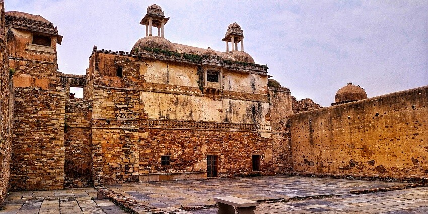 A majestic palace with intricate architecture featuring large domes and arched windows