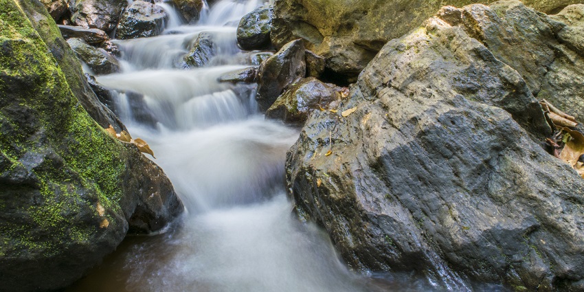 A close-up image of a waterfall flowing down a rocky path
