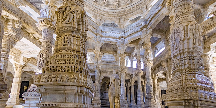 A detailed view of the intricately carved pillars in the Ranakpur Jain Temple, a famous temple near Mount Abu.
