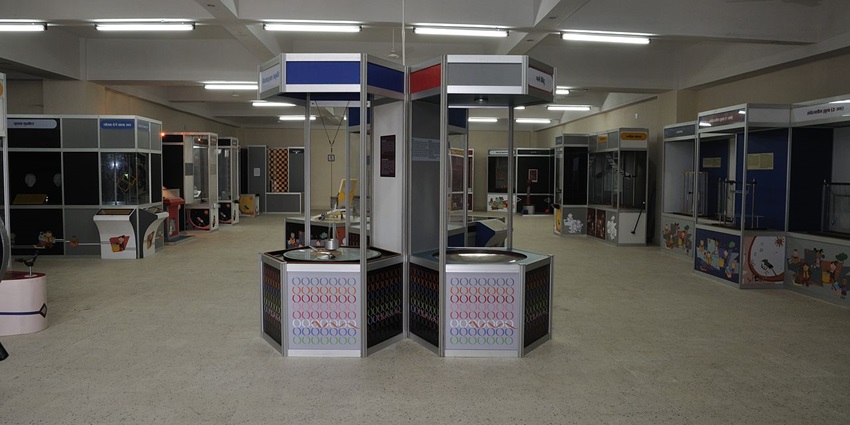 Interior view of an interactive science gallery with hands-on exhibits and bright displays