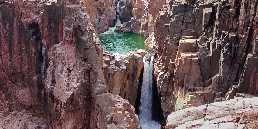Raneh Falls near Khajuraho temples, features a dramatic fall with rugged rock formations
