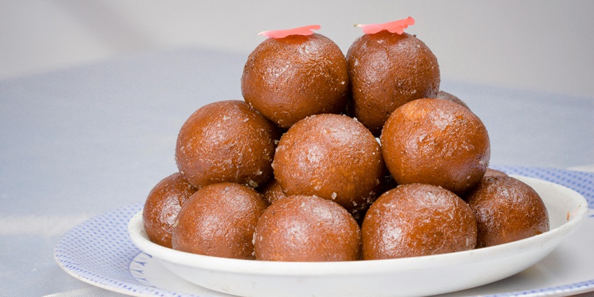 An images of rasgulla: spongy chhena dessert with syrupy sweetness, ideal post-meal.