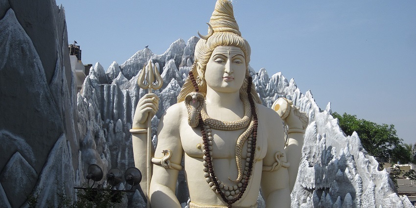 A statue of Lord Shiva, depicted with a third eye, wearing a snake around his neck.