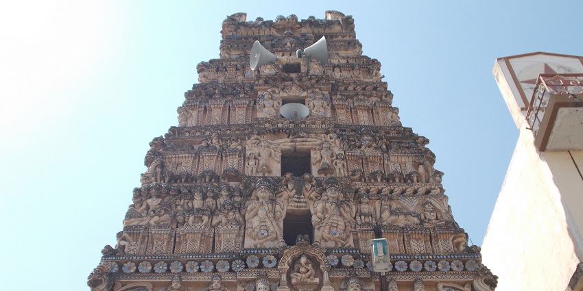 A traditionally architected temple with various sculptures carved on its outer wall