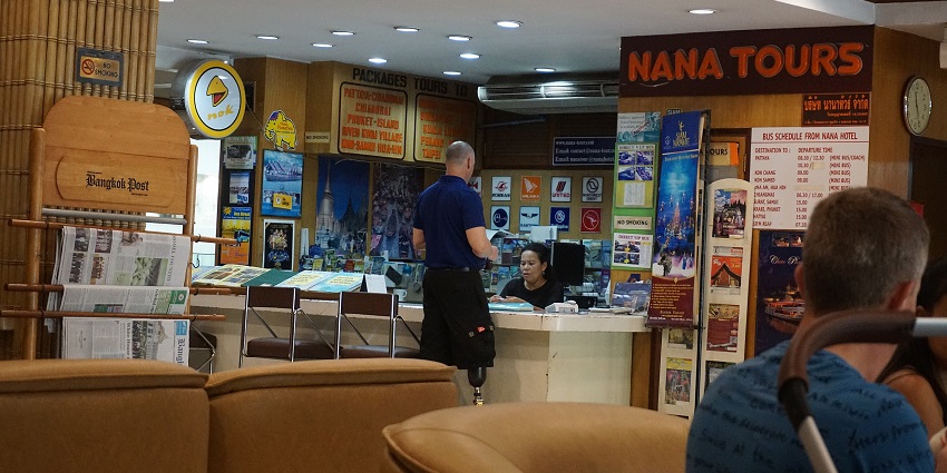 obby area of a hotel in Bangkok. One person is enquiring about Nana tours at the reception.