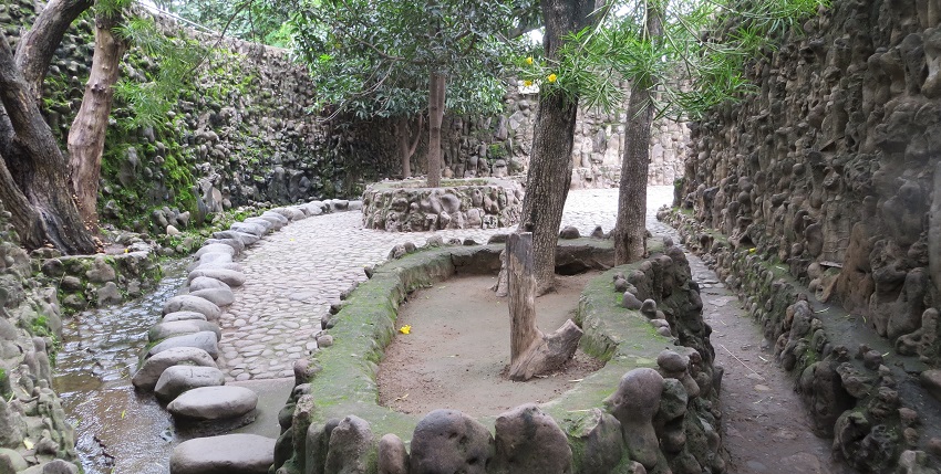 Intricate sculptures and an artistic structure made from waste materials at Rock Garden.