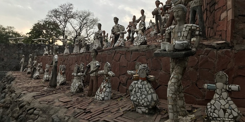 Friends posing with unique sculptures in Chandigarh’s Rock Garden.