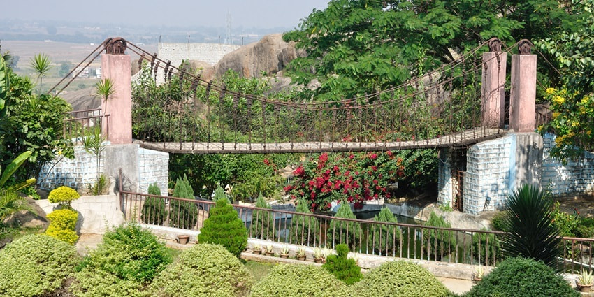 Suspension bridge at Gonda Hill in Ranchi with lush green landscape under clear skies