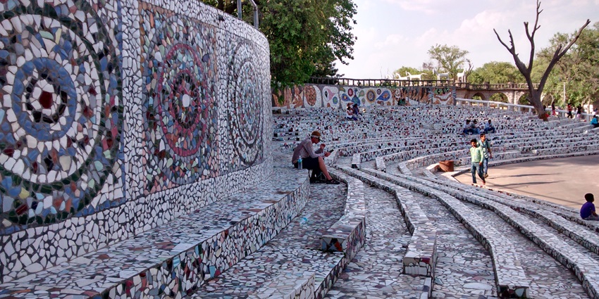 A picture of visitors' stands at a rock garden with marble art done on them