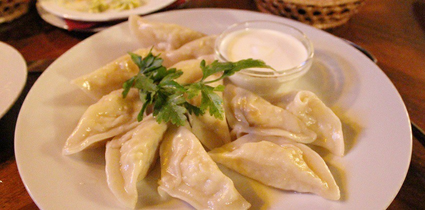 A plate of freshly cooked traditional Russian dumpling dish, served on a white plate