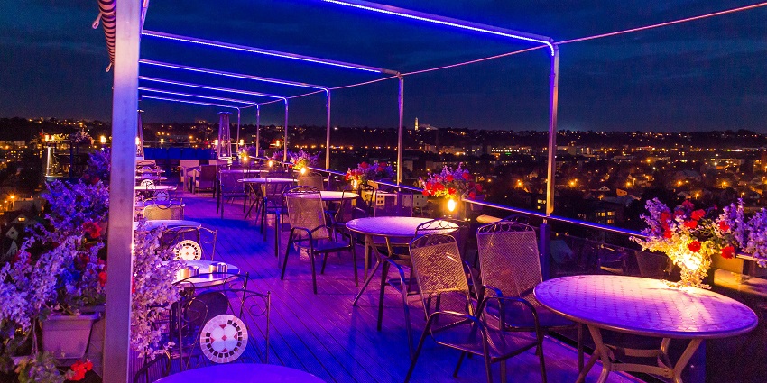 Rooftop cafes near Clock Tower offer stunning views of illuminated Mehrangarh Fort.