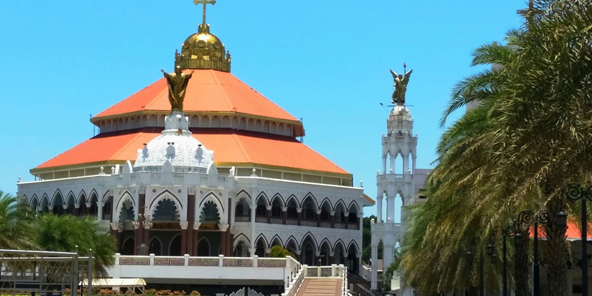 A view of the pristine white church in Chennai, Tamil Nadu, surrounded by lush greenery.
