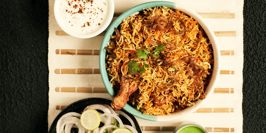 Exquisite chicken biryanis served at Royal Dining served with onions and lemons