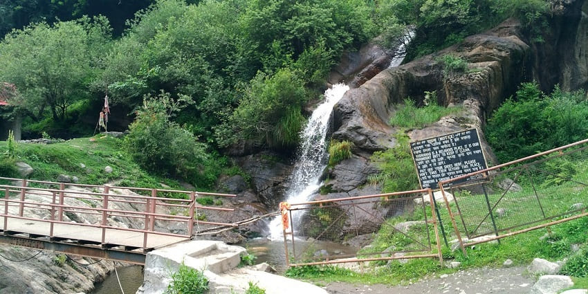 A picture of a waterfall cascading down a hill in the trails for Kheer Ganga Trekking