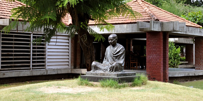 The statue of Mahatma Gandhi commemorating his works, sits outside Sabarmati Ashram.