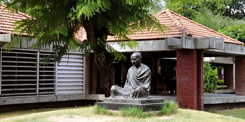 Gandhi statue at Sabarmati Ashram, capturing a solemn tribute in a serene setting.