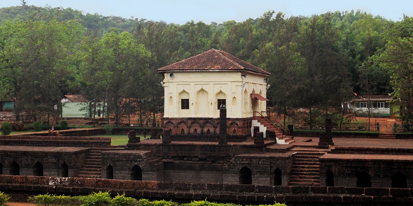 Distant view of the mosque surrounded by the trees and a beautiful garden