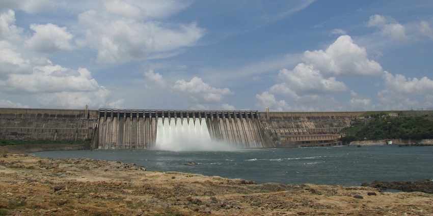 Crest gates of Nagarjuna Sagar with detailed ironwork and surrounding scenic view.