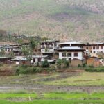 A scenic village amongst the wilderness of Bhutan with mountains in the background