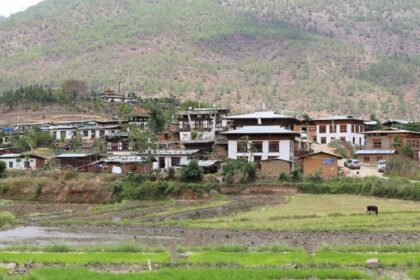 A scenic village amongst the wilderness of Bhutan with mountains in the background