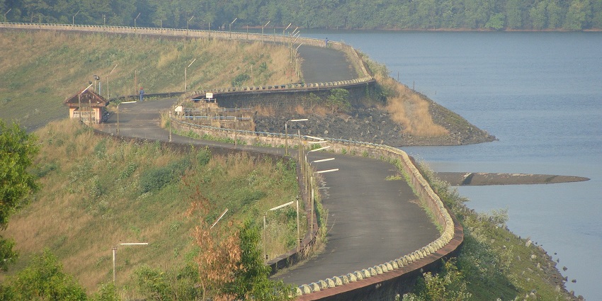 An aerial picture of a dam in Goa with a water body below it