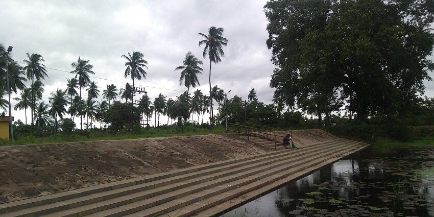Steps beside the pond of Sri Kumararama Bhimerswara temple, with tall palms in the background